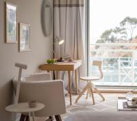 a living room with a table and chairs and a window at Hotel Bellevue Dubrovnik in Dubrovnik