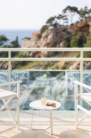 a pair of sunglasses and a plate on a table on a balcony at Hotel Bellevue Dubrovnik in Dubrovnik