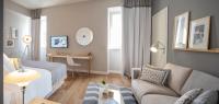 a bedroom with a bed and a living room at Hotel Bellevue Dubrovnik in Dubrovnik