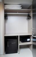 a room with a white desk with a microwave and a drawer at Porto Kaeté Hotel in Maceió