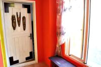 an orange room with a door and a window at 依比鴨鴨水岸會館 Ducking House in Ruisui