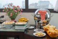 a buffet with bread and other foods on a table at Hotel De La Seine in Hanoi