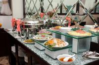 a buffet with plates of food on a table at Hotel De La Seine in Hanoi