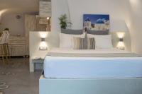 Postel nebo postele na pokoji v ubytování Stoa Cave Villas