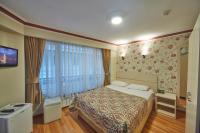 A bed or beds in a room at Hotel Akcinar