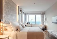 a bedroom with a large bed with a view of the ocean at Hotel Bellevue Dubrovnik in Dubrovnik