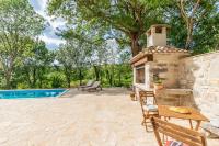 an outdoor patio with a fireplace and a swimming pool at Casa di nonno Giovanni in Buzet