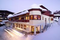 a large house with snow on top of it at Appartements Holiday in Ellmau