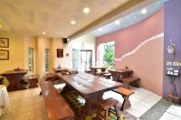 a dining room with wooden tables and benches at TFG B&amp;B in Lugu Lake