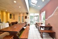 a restaurant with wooden tables in a room at TFG B&amp;B in Lugu Lake