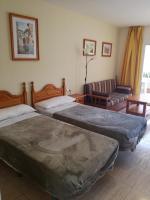 Łóżko lub łóżka w pokoju w obiekcie Apartamentos Parque Carolina