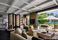 a living room with a couch and a table at Rosewood Phuket in Patong Beach