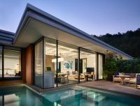 a house with a pool in front of it at Rosewood Phuket in Patong Beach