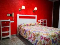 Postel nebo postele na pokoji v ubytování Hotel Doña Carmen