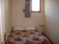 a bed in a small room with a window at BOROT2 in Lanslebourg-Mont-Cenis