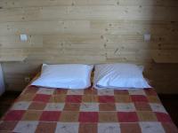 a bedroom with a bed with two pillows at BOROT2 in Lanslebourg-Mont-Cenis