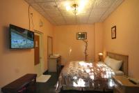 a bedroom with a bed and a flat screen tv at Cing Jing Homeland Resort Villa in Ren&#39;ai