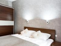 Łóżko lub łóżka w pokoju w obiekcie VacationClub – Olympic Park Apartament A412