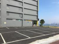 an empty parking lot in front of a building at Watermark Hotel - Sizihwan in Kaohsiung