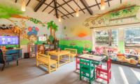 a childrens room with a table and chairs and a large window at Taj Holiday Village Resort & Spa, Goa in Candolim