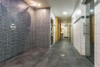 a corridor of a bathroom with a wall of mosaic tiles at Résidence Pierre &amp; Vacances Premium Les Alpages de Chantel in Arc 1800