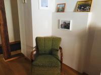 a green chair sitting in a corner of a room at Posthof Kerstenhausen in Borken