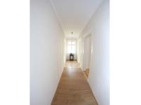 a hallway with white walls and a wooden floor at Posthof Kerstenhausen in Borken