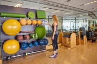 a woman taking a picture of a bunch of exercise balls at Four Seasons Hotel Hong Kong in Hong Kong