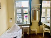 a hospital room with a bed and a window at Pension Karina Schwerin in Schwerin