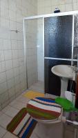 a bathroom with a shower and a toilet and a sink at Pousada Colina Da Neve in São Joaquim