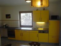 a yellow kitchen with a sink and a window at Appartement Pichler in Radstadt