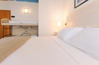Posteľ alebo postele v izbe v ubytovaní Hotel Fra I Pini