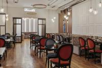 a restaurant with tables and chairs and a bar at Continental Hotel in Odesa