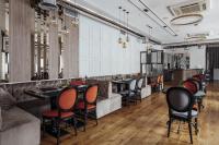 a restaurant with a bar with chairs and tables at Continental Hotel in Odesa