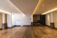 a large room with a wooden floor and white walls at Marsella 45 in Hermosillo