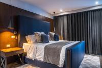 a bedroom with a large bed with a blue headboard at Marsella 45 in Hermosillo