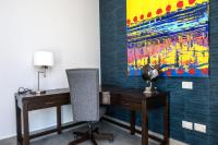 a desk with a chair and a painting on the wall at Marsella 45 in Hermosillo