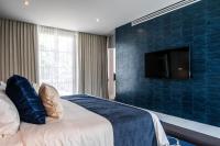 a bedroom with a bed and a tv on a wall at Marsella 45 in Hermosillo