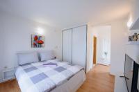 a white bedroom with a bed and a tv at Pension Kathi in Brist