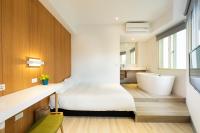 a bathroom with a large bed and a bath tub at Meander Taipei Hostel - Ximending in Taipei