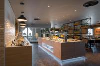 a restaurant with a counter with food on it at Premier Inn Dubai Al Jaddaf in Dubai