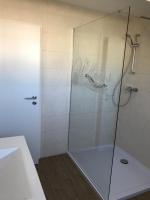 a shower with a glass door in a bathroom at Pensione da Vito in Greifswald