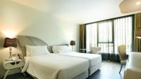 Postel nebo postele na pokoji v ubytování Le Tada Parkview Hotel
