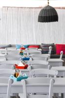 Un grupo de sillas blancas con juguetes sobre ellas. en Fisilanis Beachfront Hotel, en Logaras