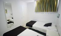 Postel nebo postele na pokoji v ubytování Apartamentos Arco Iris