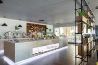 a restaurant with a counter with plants on it at Premier Inn Dubai Al Jaddaf in Dubai