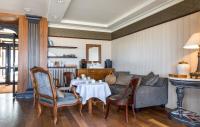 a living room with a couch and a table and chairs at Hôtel Le Beaufort in Saint Malo