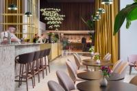 Un restaurante con mesas y sillas y un bar. en Exe Lev, en Liubliana
