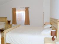 a bedroom with a bed with white sheets and a window at Agroturism Stara Štala in Borut