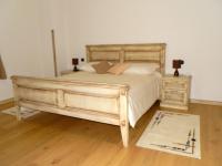 a bedroom with a large wooden bed and a rug at Agroturism Stara Štala in Borut